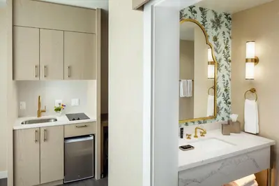 a bathroom with a sink and a mirror at The Benson Hotel & Faculty Club in Aurora