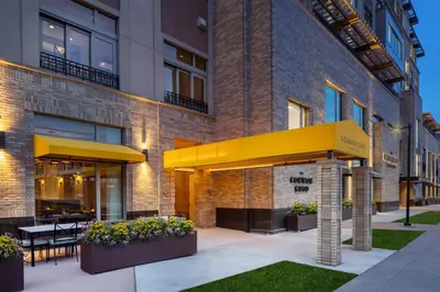 an exterior view of a building with a restaurant at The Benson Hotel & Faculty Club in Aurora