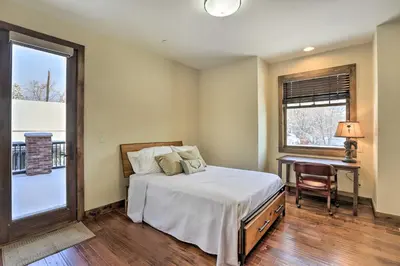 a bedroom with a bed and a desk and a window at half Mi to Dtwn Golden Gem with Patios! in Golden