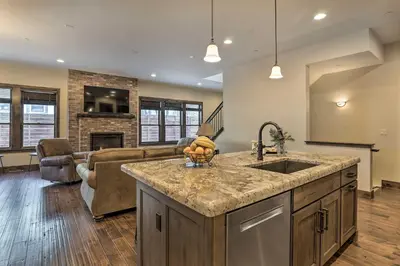 a kitchen with a sink and a living room at half Mi to Dtwn Golden Gem with Patios! in Golden