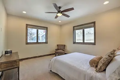 a bedroom with a bed and a ceiling fan at half Mi to Dtwn Golden Gem with Patios! in Golden