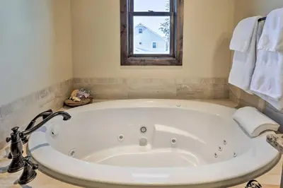 a large white tub in a bathroom with a window at half Mi to Dtwn Golden Gem with Patios! in Golden
