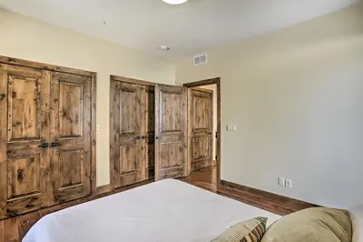 a bedroom with wooden doors and a bed in it at half Mi to Dtwn Golden Gem with Patios! in Golden