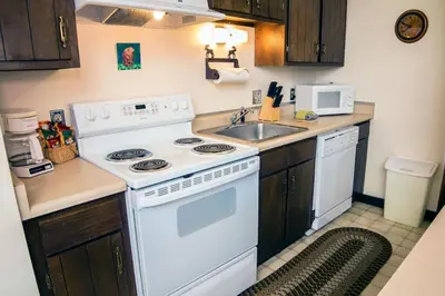 a kitchen with a white stove and a sink at Elkhorn One Bedroom Condo with River View from Deck and Walking Distance to Estes Park - #3262 in Estes Park