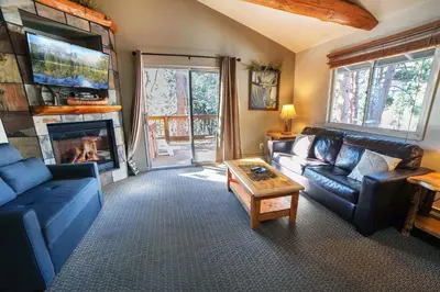 a living room with two couches and a fireplace at King Bed Condo with Personal Hot Tub on Deck with River View condo in Estes Park