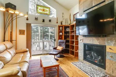 a living room with a couch and a fireplace at Spacious Frisco Retreat with Private Hot Tub! in Frisco