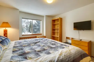 a bedroom with a bed and a flat screen tv at Spacious Frisco Retreat with Private Hot Tub! in Frisco