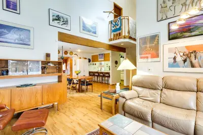 a living room with a couch and a table at Spacious Frisco Retreat with Private Hot Tub! in Frisco