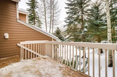 a porch with a white railing next to a house at Spacious Frisco Retreat with Private Hot Tub! in Frisco