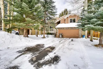 a driveway covered in snow in front of a house at Spacious Frisco Retreat with Private Hot Tub! in Frisco