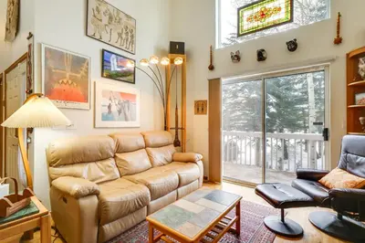 a living room with a couch and a table at Spacious Frisco Retreat with Private Hot Tub! in Frisco