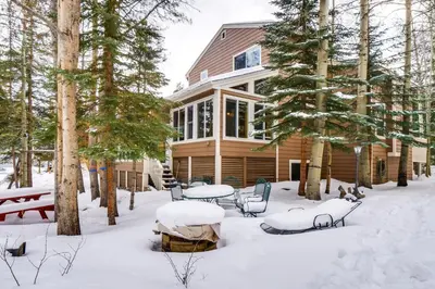 a house in the snow with tables and chairs at Spacious Frisco Retreat with Private Hot Tub! in Frisco