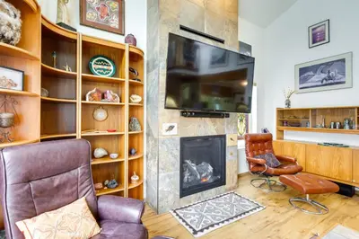 a living room with a fireplace and a television at Spacious Frisco Retreat with Private Hot Tub! in Frisco