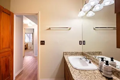 a bathroom with a sink and a mirror at Meandering Moose Apartment Vacation Rental in Black Hawk
