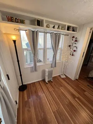 a living room with a window and a wooden floor at Spacious, Cal King Bed, Sleeps 6, Full Kitchen in Loveland