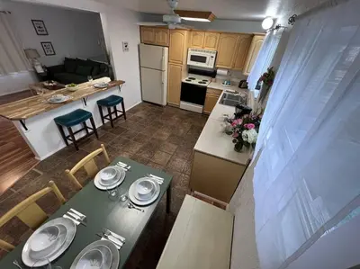 a kitchen and dining room with a table and chairs at Spacious, Cal King Bed, Sleeps 6, Full Kitchen in Loveland