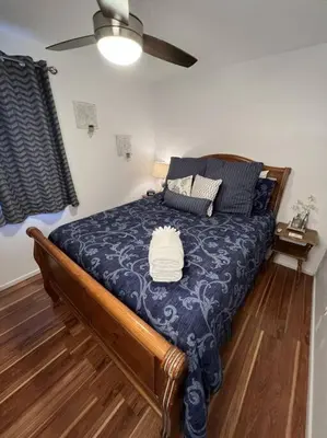 a bedroom with a bed with a blue comforter at Spacious, Cal King Bed, Sleeps 6, Full Kitchen in Loveland