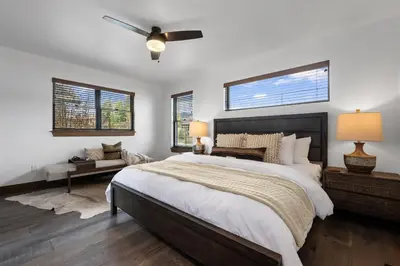 a bedroom with a large bed and a ceiling fan at Rocky Mountain Gem! Two Large patios, Fireplace and Private Jacuzzi in Estes Park