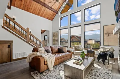 a living room with a couch and a table at Rocky Mountain Gem! Two Large patios, Fireplace and Private Jacuzzi in Estes Park