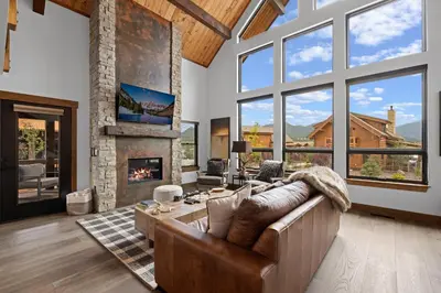 a living room with a couch and a fireplace at Elk Haven! Two Large Patios, Private Jacuzzi, Indoor/Outdoor Fireplace in Estes Park