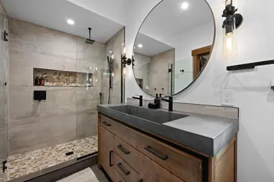 a bathroom with a sink and a mirror at Elk Haven! Two Large Patios, Private Jacuzzi, Indoor/Outdoor Fireplace in Estes Park