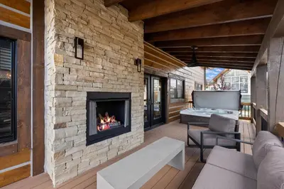 a fireplace in the living room of a house at Elk Haven! Two Large Patios, Private Jacuzzi, Indoor/Outdoor Fireplace in Estes Park