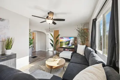 a living room with a couch and a ceiling fan at Peaceful Home w/ 4BR, Big Yard and amazing art in Denver