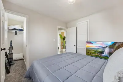 a bedroom with a bed and a painting on the wall at Peaceful Home w/ 4BR, Big Yard and amazing art in Denver