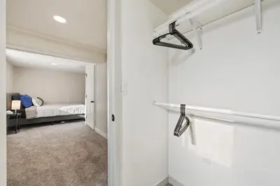 a room with a door and a bedroom with a bed at Peaceful Home w/ 4BR, Big Yard and amazing art in Denver