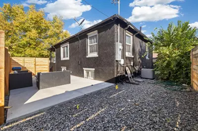 a small house with a gravel driveway at Peaceful Home w/ 4BR, Big Yard and amazing art in Denver