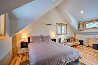 a bedroom with a large bed in a attic at Updated Boulder Studio about 1 Mi to Pearl Street in Boulder