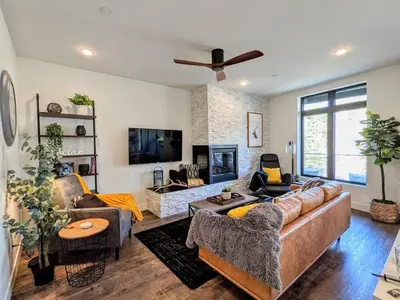 a living room with a couch and a tv at HostWise Stays - The River West - Hot Tub, Parking, Fire Pit, and more in Silverthorne