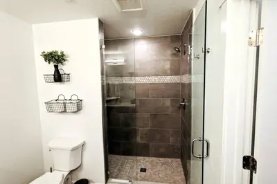 a bathroom with a toilet and a glass shower at HostWise Stays - The River West - Hot Tub, Parking, Fire Pit, and more in Silverthorne