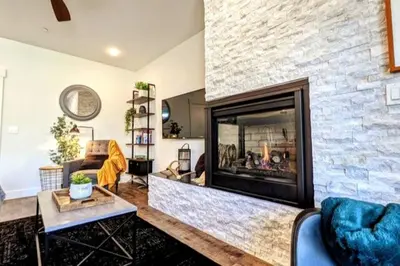 a living room with a fireplace and a couch at HostWise Stays - The River West - Hot Tub, Parking, Fire Pit, and more in Silverthorne