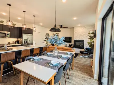 a kitchen and living room with a table and chairs at HostWise Stays - The River West - Hot Tub, Parking, Fire Pit, and more in Silverthorne