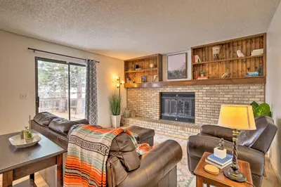 a living room with leather furniture and a fireplace at Family-Friendly Aurora Vacation Rental with Yard! in Aurora