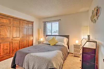 a bedroom with a bed and a large wooden cabinet at Family-Friendly Aurora Vacation Rental with Yard! in Aurora
