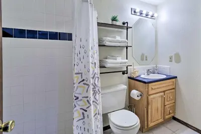 a bathroom with a toilet and a sink and a mirror at Family-Friendly Aurora Vacation Rental with Yard! in Aurora