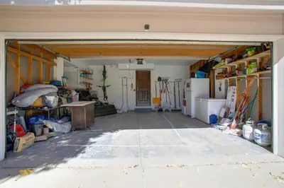a garage with a door open and a room with tools at Family-Friendly Aurora Vacation Rental with Yard! in Aurora