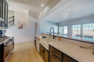 a large kitchen with white walls and wooden floors at Eagle Ridge Retreat in Granby