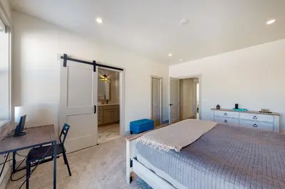 a bedroom with a bed and a desk and a table at Eagle Ridge Retreat in Granby