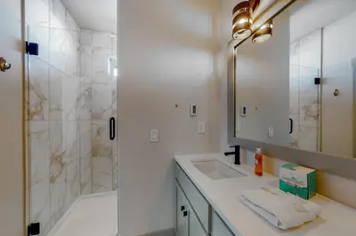 a bathroom with a shower and a sink and a mirror at Eagle Ridge Retreat in Granby