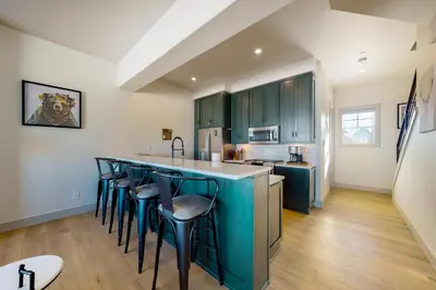 a kitchen with a blue island with bar stools at Eagle Ridge Retreat in Granby