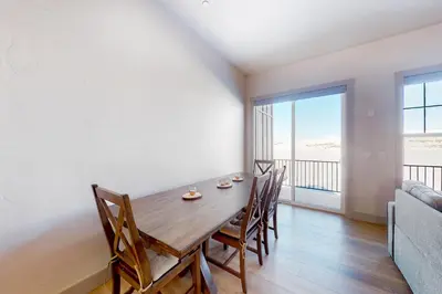 a dining room with a table and chairs and a large window at Eagle Ridge Retreat in Granby