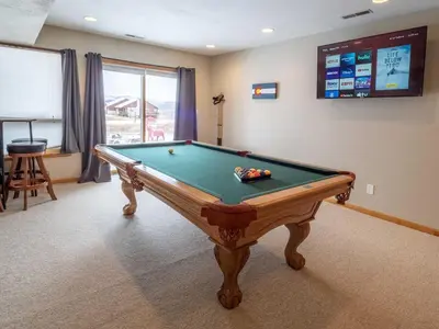 a pool table in a room with a tv at Overlook, 0015 in Granby