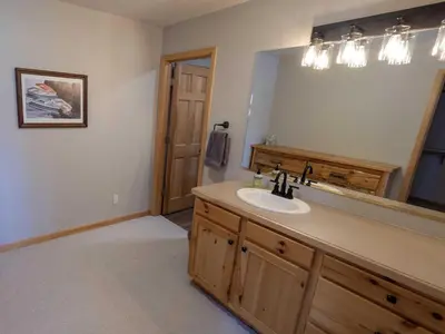 a bathroom with a sink and a large mirror at Overlook, 0015 in Granby