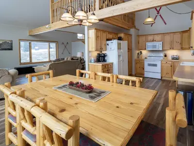 a kitchen and living room with a wooden dining room table at Overlook, 0015 in Granby