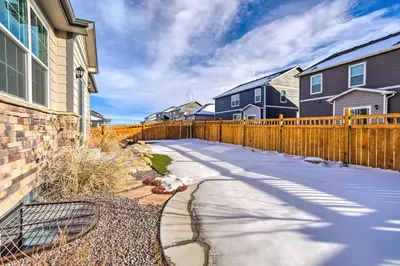 a driveway in front of a house with a fence at 10 Mi to DIA Spacious Aurora House with Yard! in Aurora