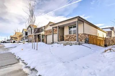 a house with snow in front of it at 10 Mi to DIA Spacious Aurora House with Yard! in Aurora