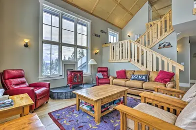 a living room with a couch and a table at Granby Home Stunning Mountain and Lake Views! in Granby